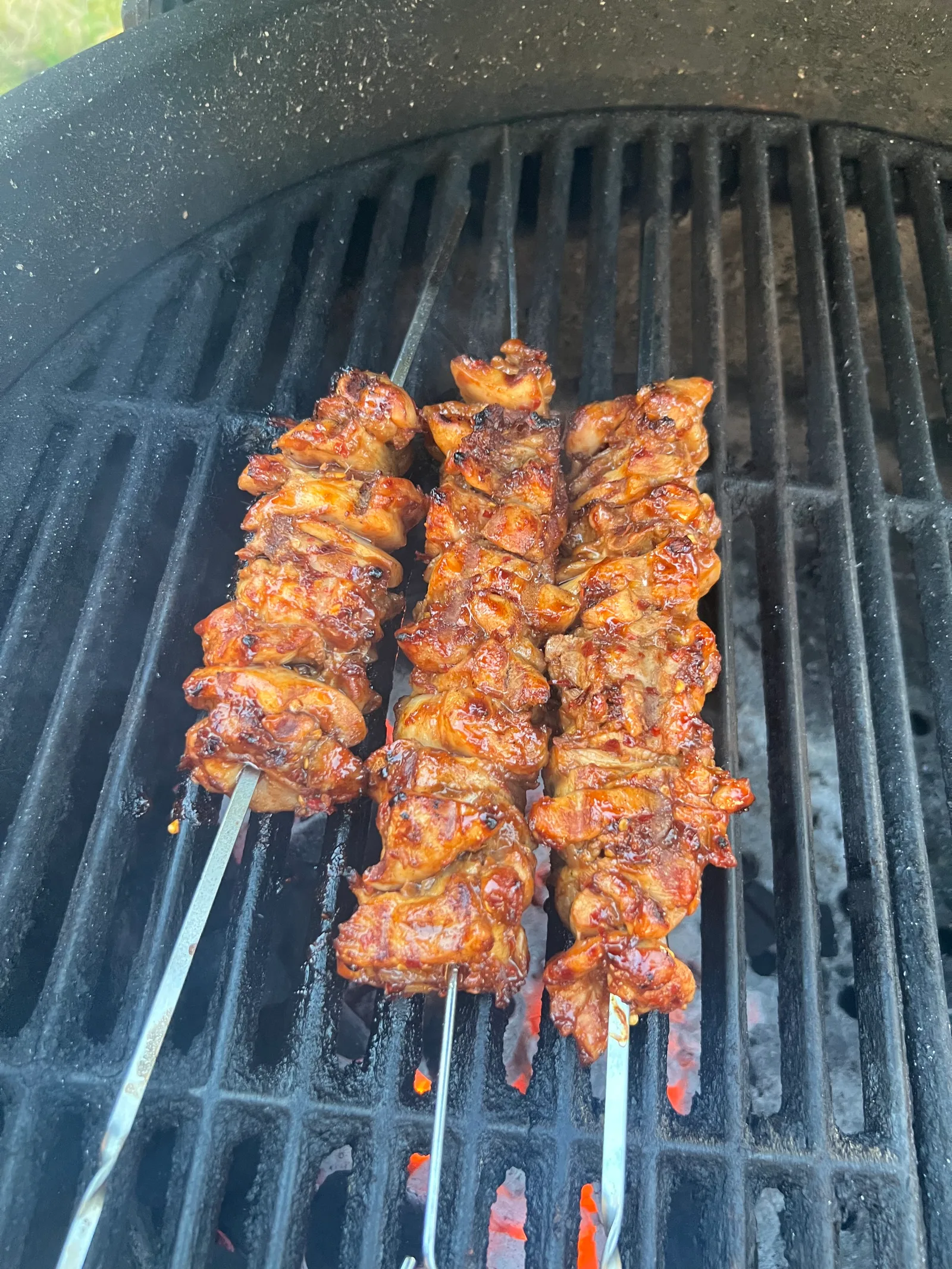 Asian-style glazed chicken kebabs on the grill.