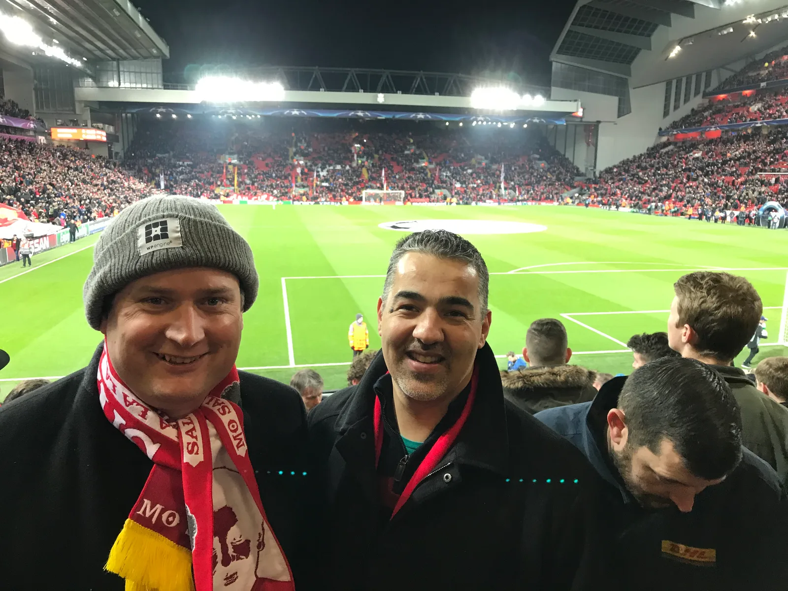 Rich and Spence in the stands at Anfield under the floodlights.