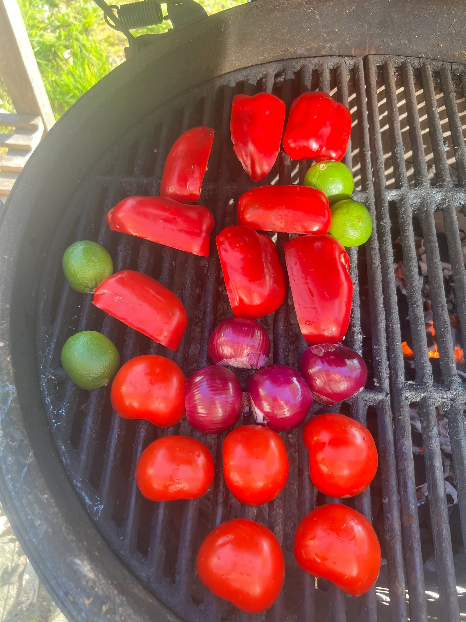 Peppers, chillies, onions, tomatoes and limes on the grill.