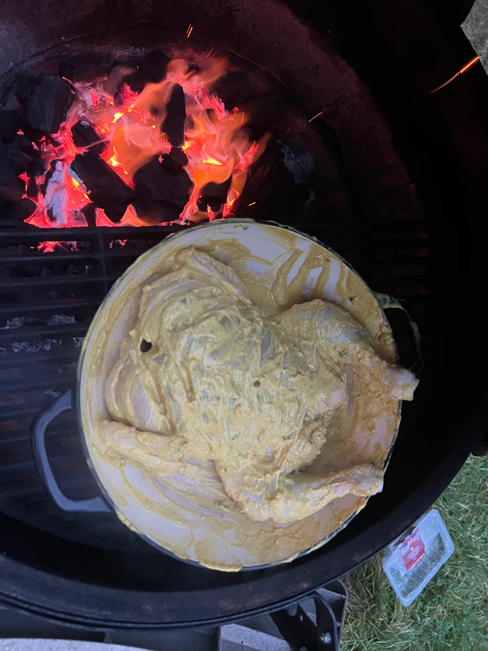 Spatchcocked chicken in yogurt marinade over roaring coals.