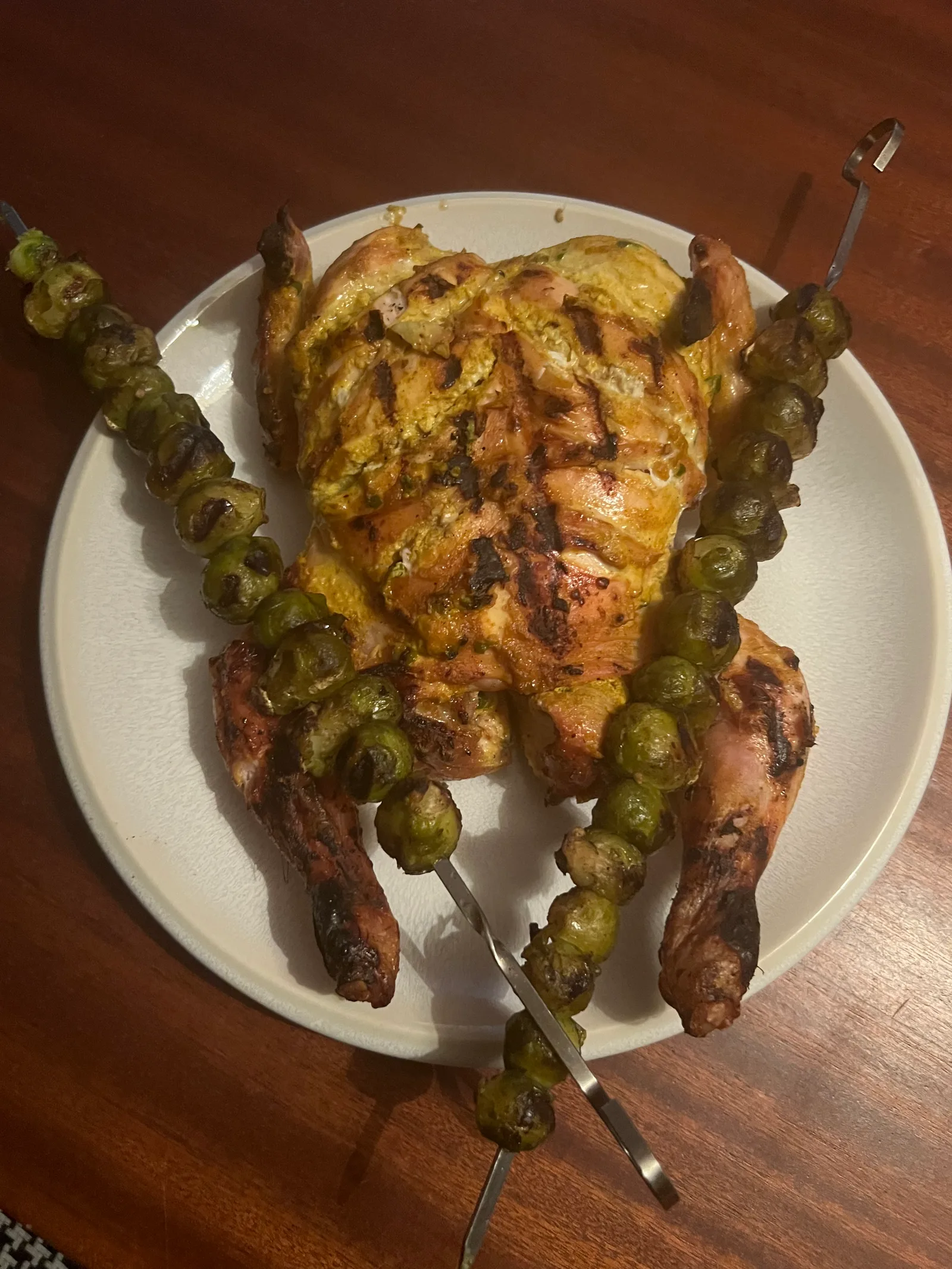 The Indian-style chicken plated with sprout skewers.
