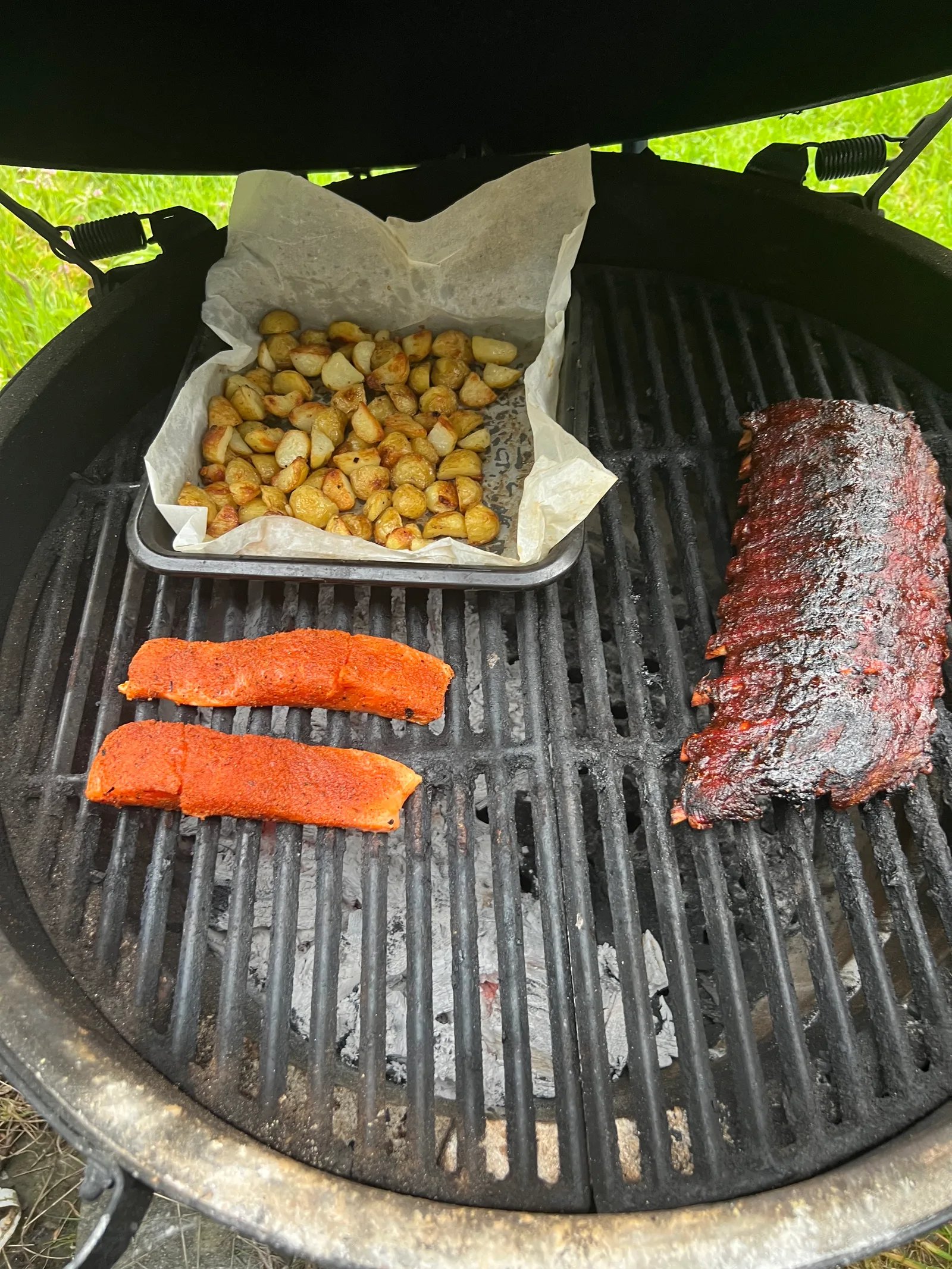 Ribs and salmon with potatoes on the grill for the final touch.