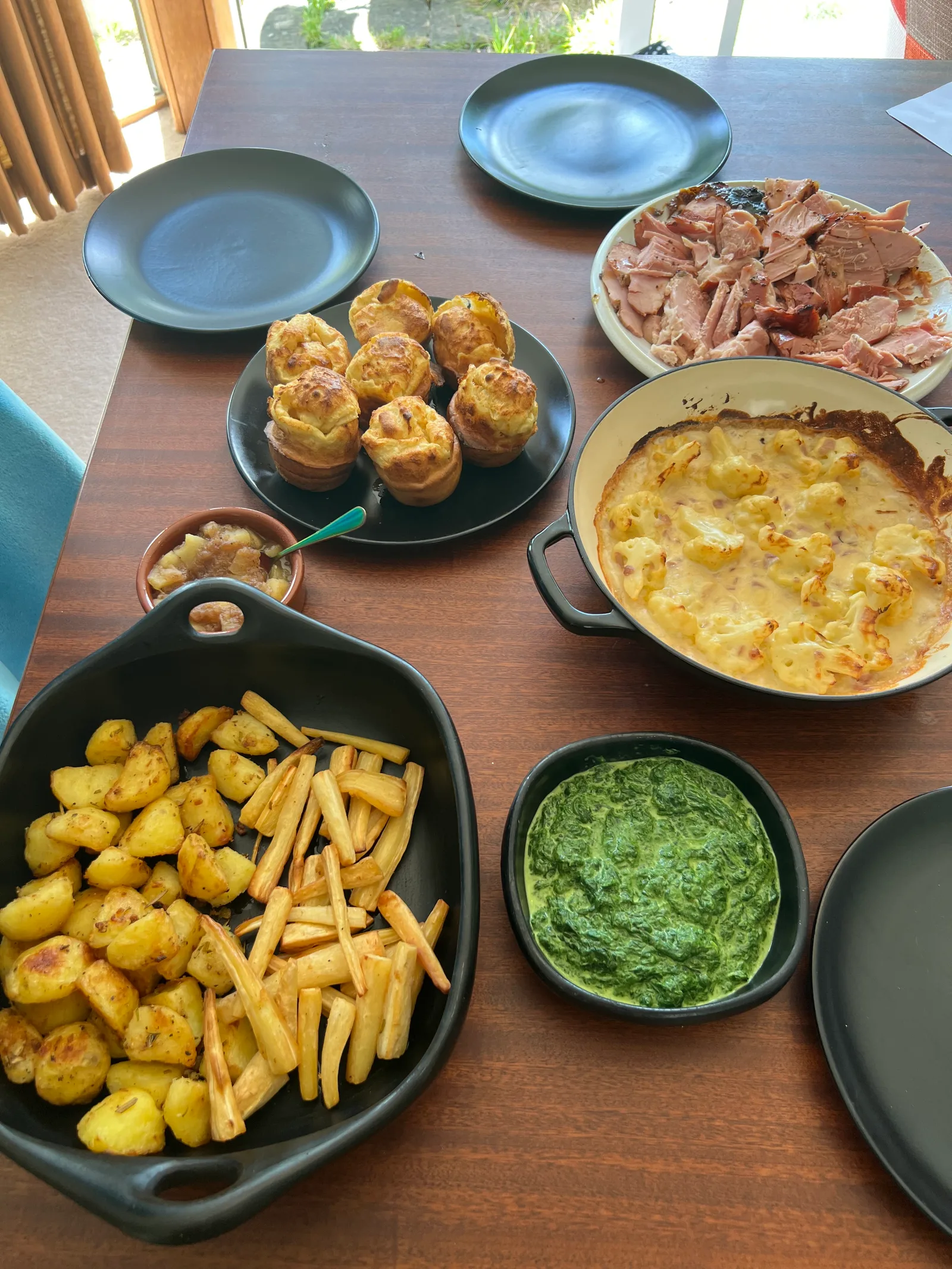 Roast spread: honey-glazed ham, yorkshires, cauliflower cheese, creamed spinach, roasties and parsnips.